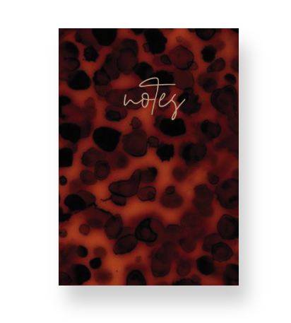 Notebook with a leopard/ classic tortoise print cover and 'notes' text on the cover
