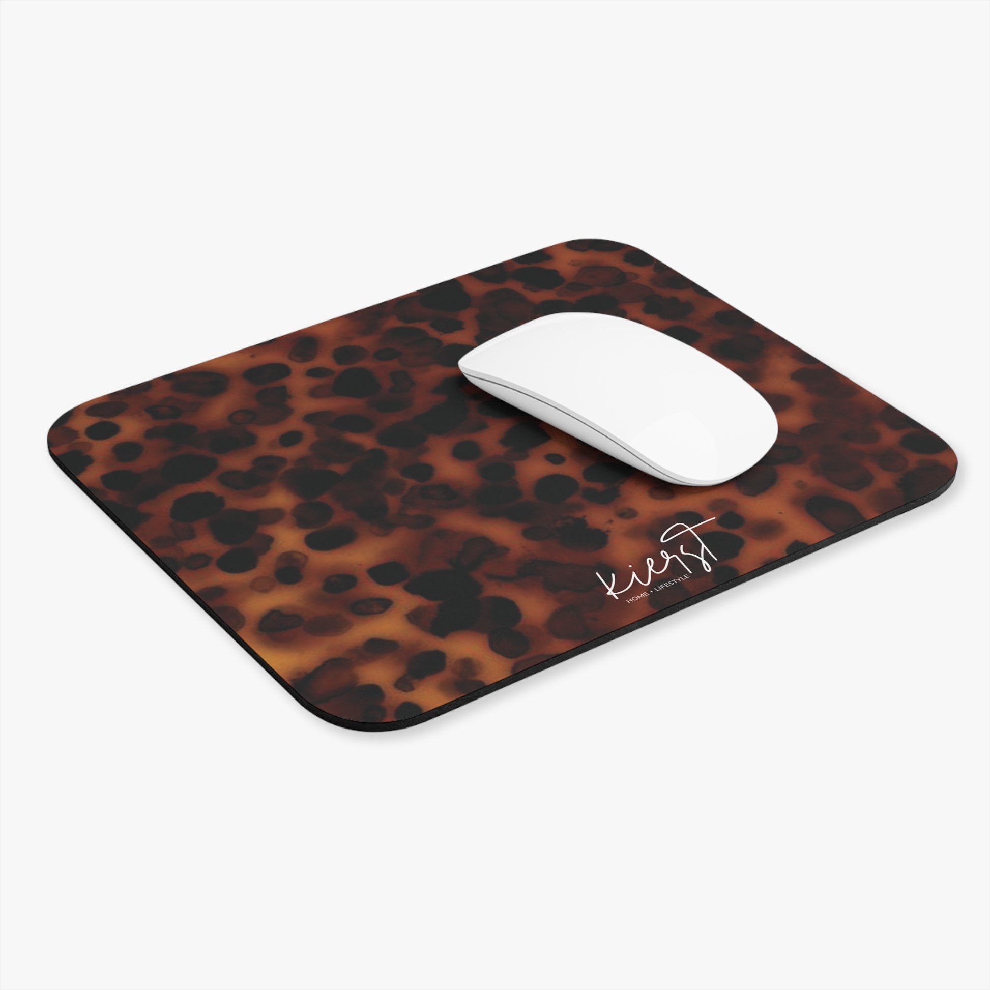 tortoiseshell print mouse pad with a white mouse on a light gray background